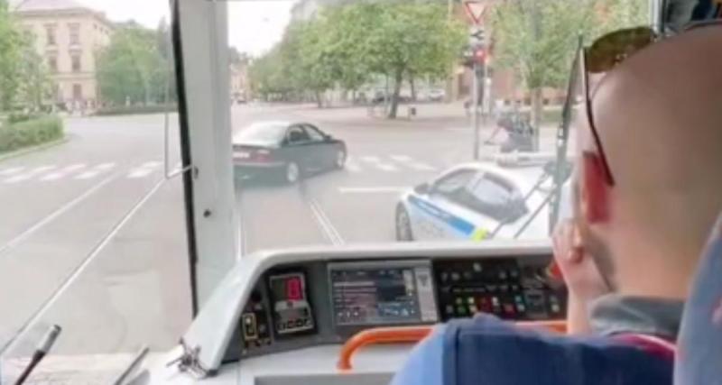  - Cette voiture fait demi-tour et grille un feu rouge, sous les yeux d'une voiture de police et d'un conducteur de tramway hilare